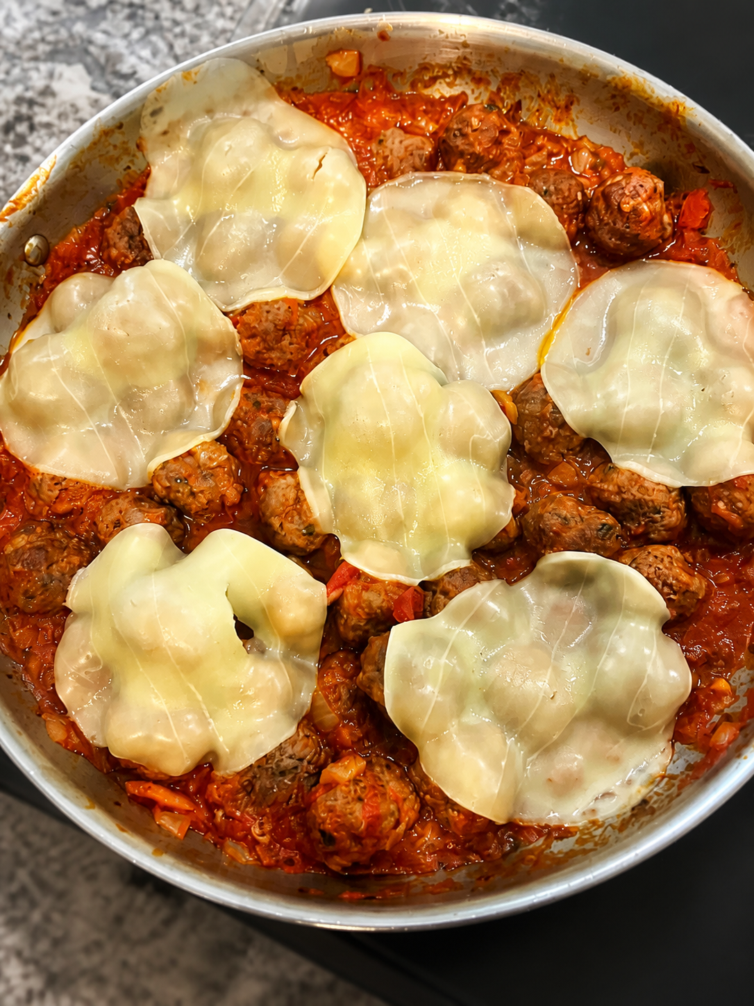 Italian-style meatballs simmered in tomato sauce and topped with melted cheese.