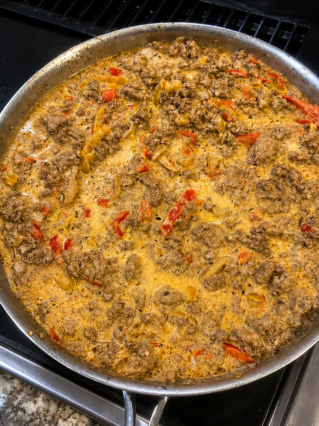 Creamy Philly cheese skillet with ground beef, bell peppers, and onions.